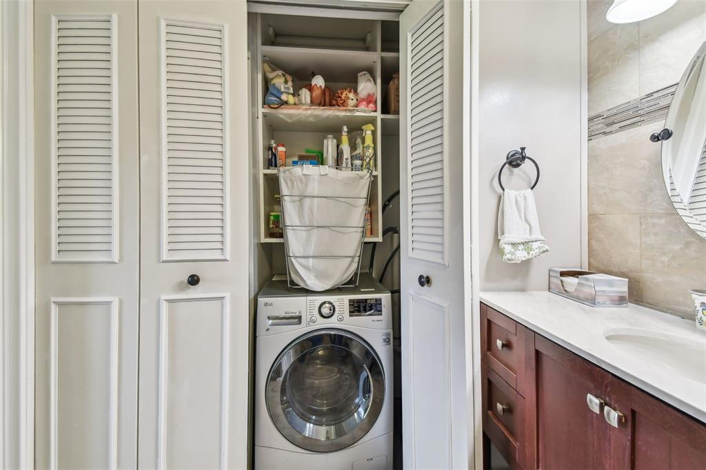 7200 Ulmerton Road, Unit E3 Largo, FL 33771 - Photo 12 of 26 a bathroom with a sink a washer and dryer