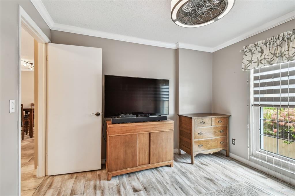 7200 Ulmerton Road, Unit E3 Largo, FL 33771 - Photo 14 of 26 a living room with furniture and flat screen tv