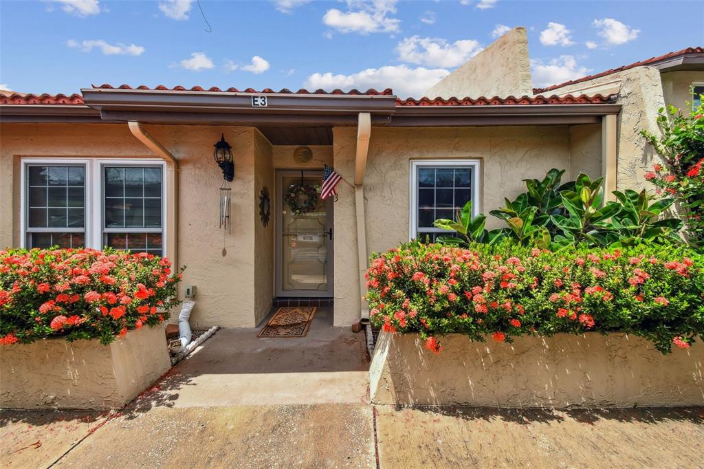 7200 Ulmerton Road, Unit E3 Largo, FL 33771 - Photo 2 of 26 a view of a balcony with flower pots