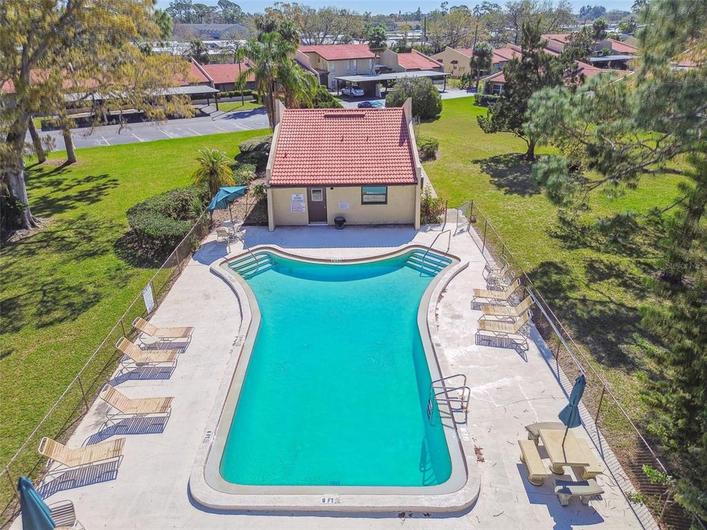 7200 Ulmerton Road, Unit E3 Largo, FL 33771 - Photo 25 of 26 an aerial view of a swimming pool with a yard and lake view