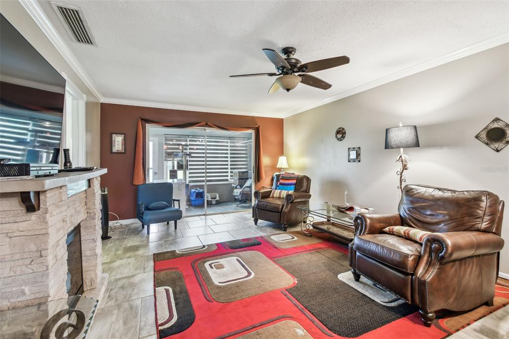7200 Ulmerton Road, Unit E3 Largo, FL 33771 - Photo 4 of 26 a living room with furniture and a fireplace
