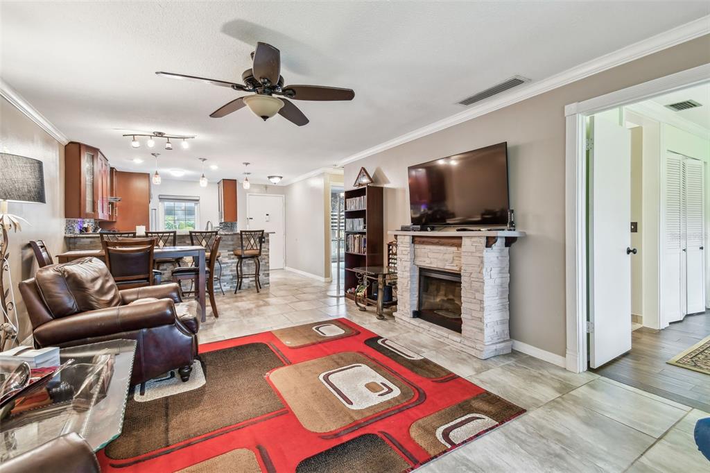 7200 Ulmerton Road, Unit E3 Largo, FL 33771 - Photo 5 of 26 a living room with furniture and a fireplace
