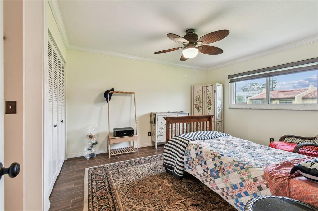 7200 Ulmerton Road, Unit E3 Largo, FL 33771 - Photo 8 of 26 a bedroom with a bed and a window