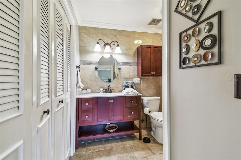 7200 Ulmerton Road, Unit E3 Largo, FL 33771 - Photo 10 of 26 a bathroom with a sink and mirror