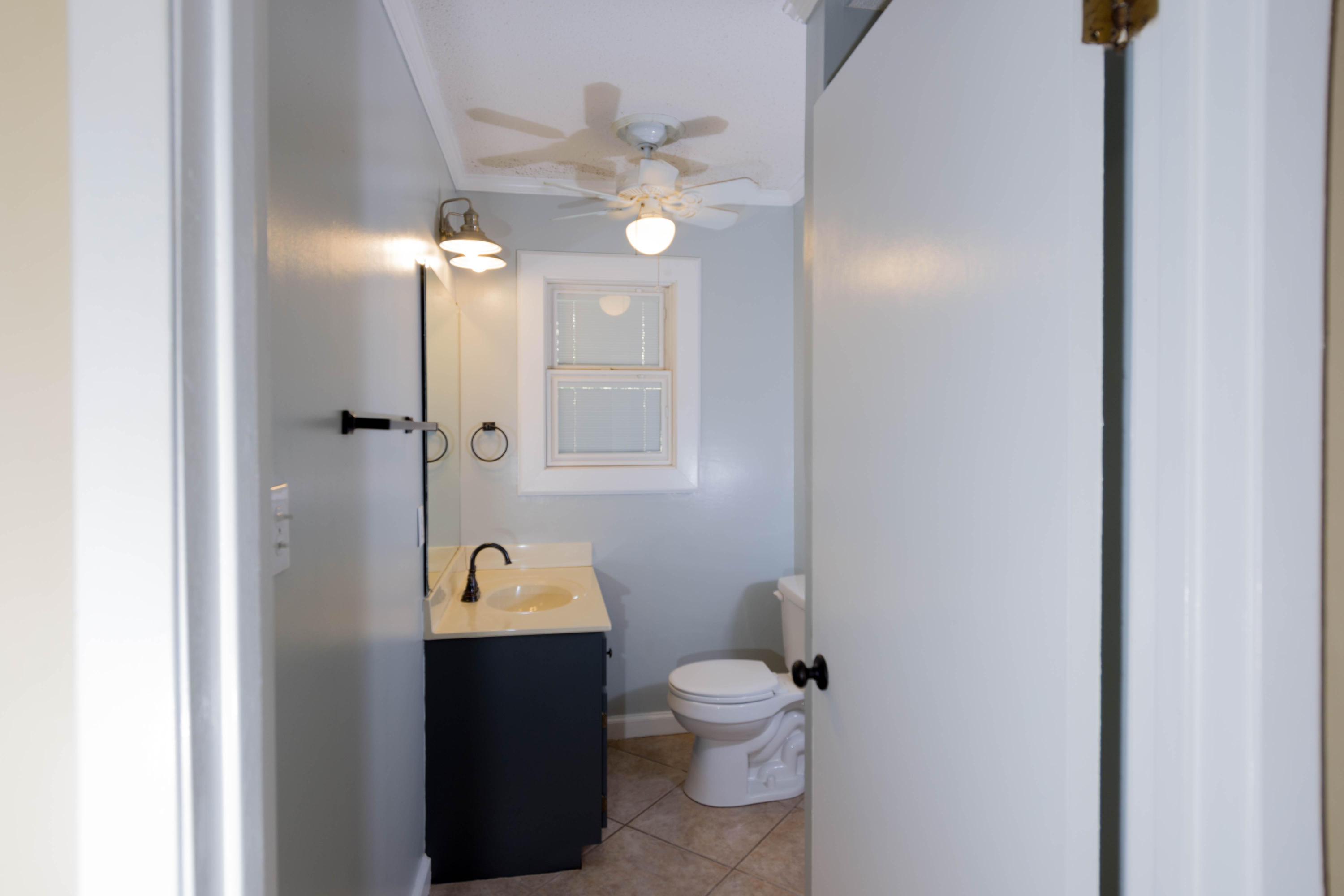 2292 Bay Grove Road Freeport, FL 32439 - Photo 12 of 47 a bathroom with a toilet a sink and mirror