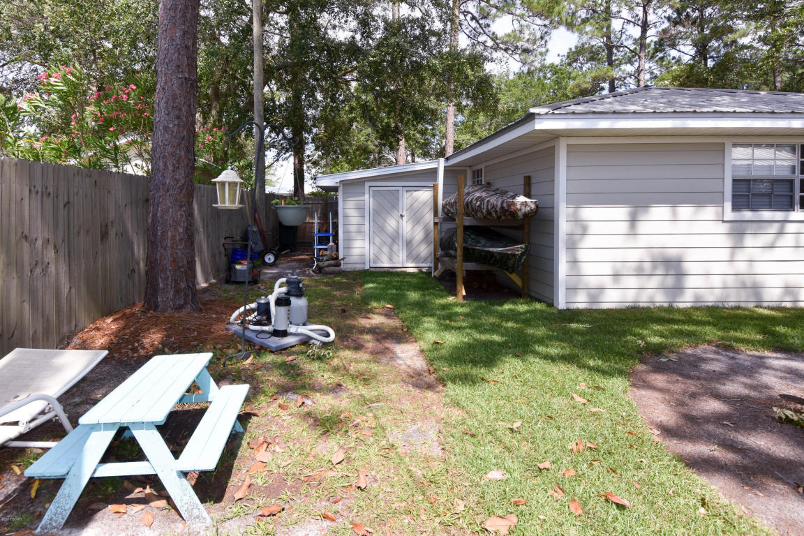 2292 Bay Grove Road Freeport, FL 32439 - Photo 39 of 47 a backyard of a house with barbeque oven fire pit table and chairs