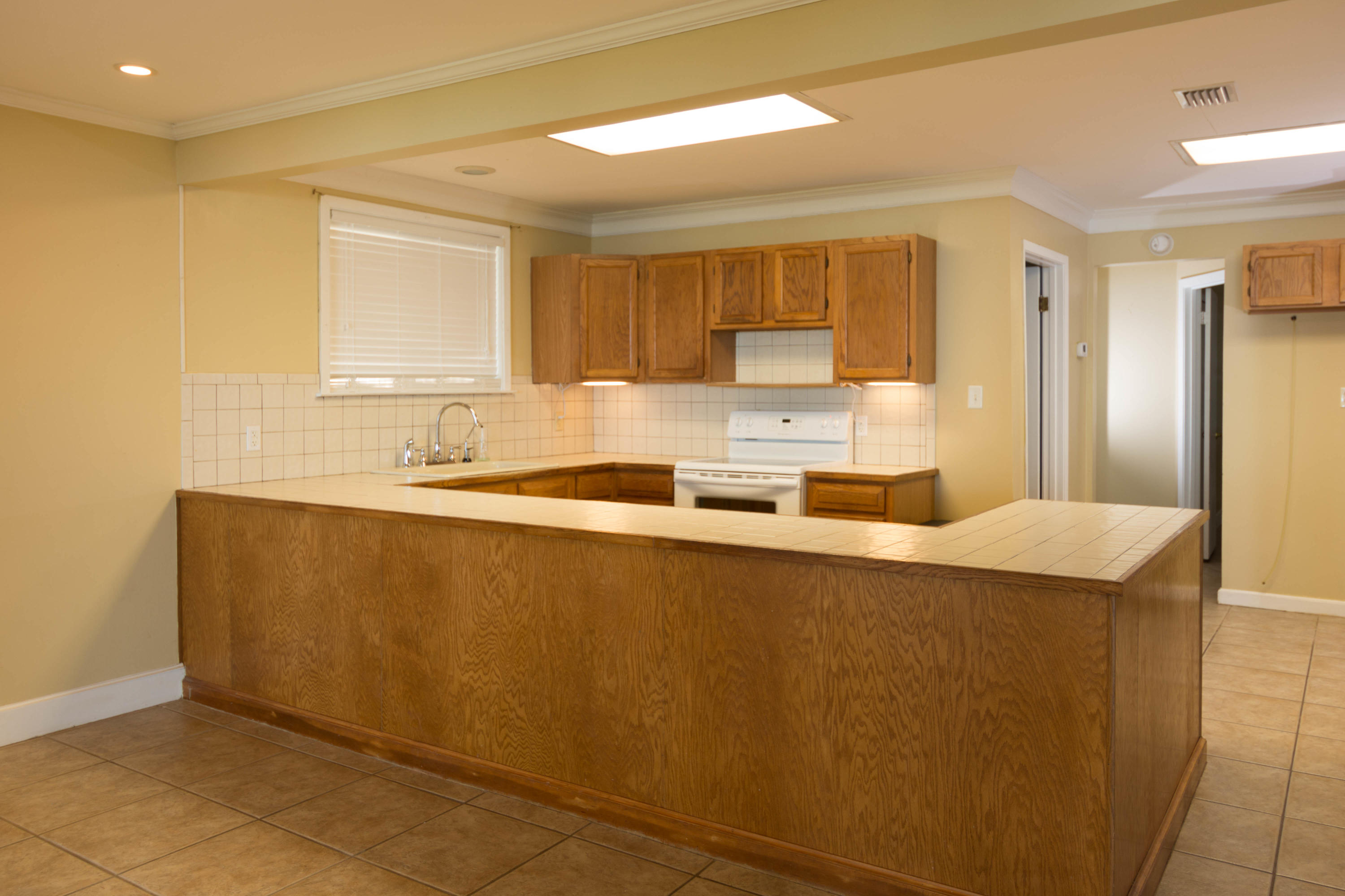 2292 Bay Grove Road Freeport, FL 32439 - Photo 8 of 47 a kitchen with stainless steel appliances granite countertop a sink a stove and a refrigerator with wooden floor