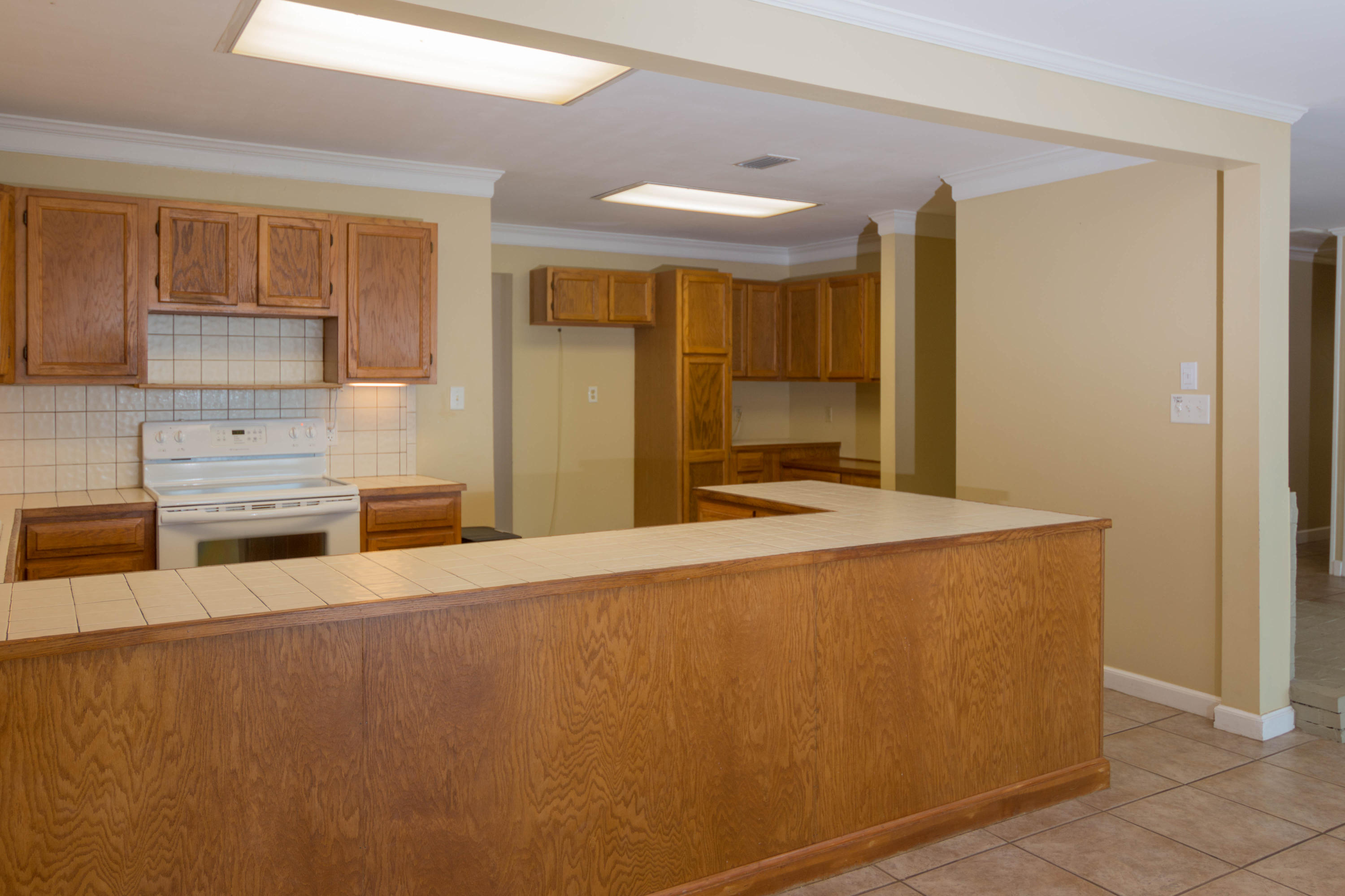 2292 Bay Grove Road Freeport, FL 32439 - Photo 9 of 47 a large kitchen with stainless steel appliances a large counter top a stove and a refrigerator