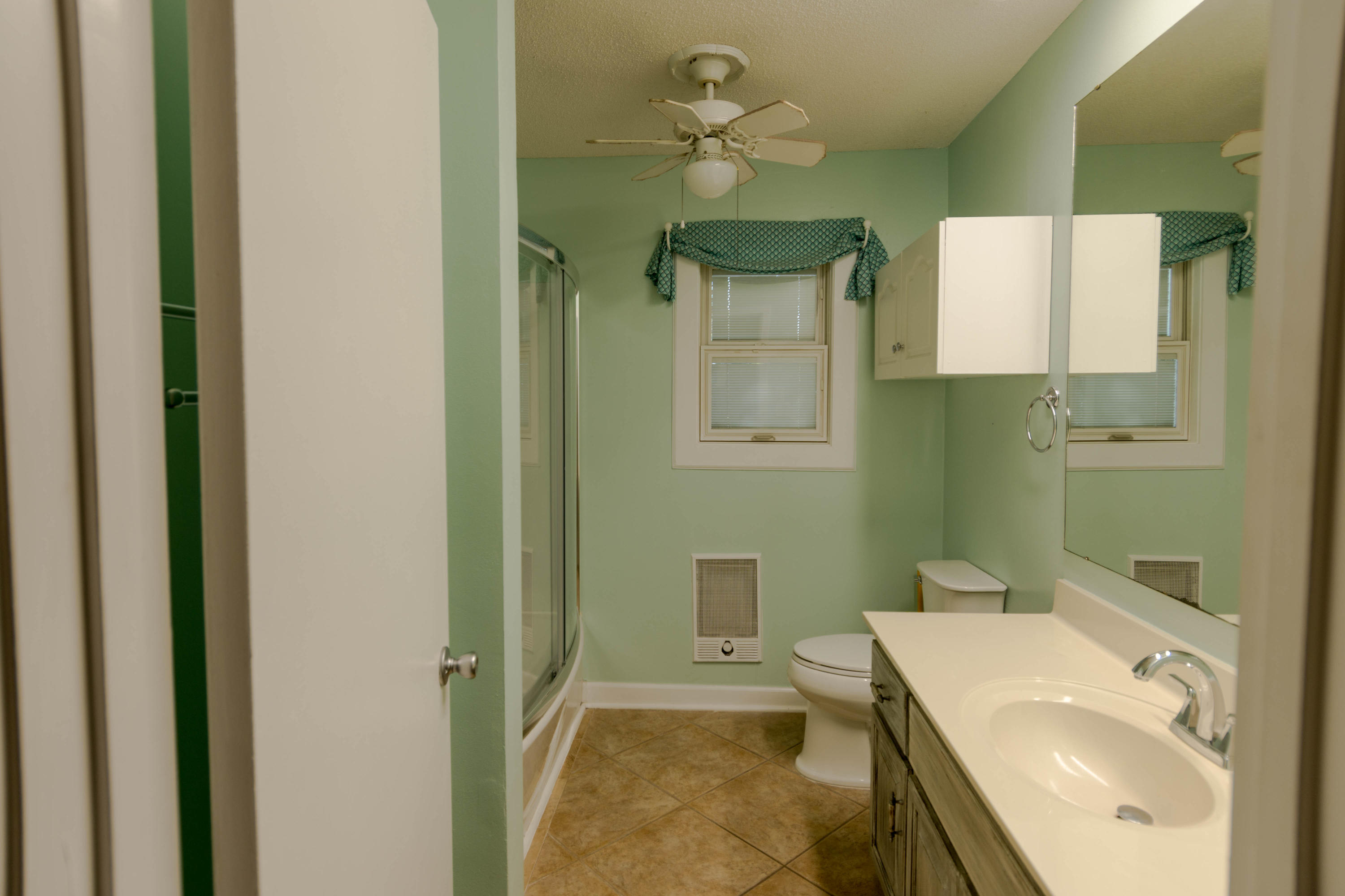 2292 Bay Grove Road Freeport, FL 32439 - Photo 10 of 47 a bathroom with a sink a toilet and a mirror