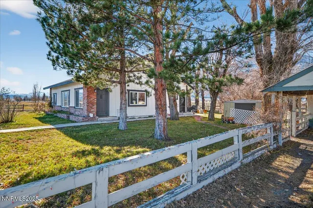 a view of a house with backyard porch and sitting area