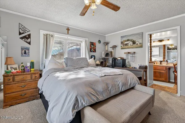 a bedroom with a bed and a painting on the wall