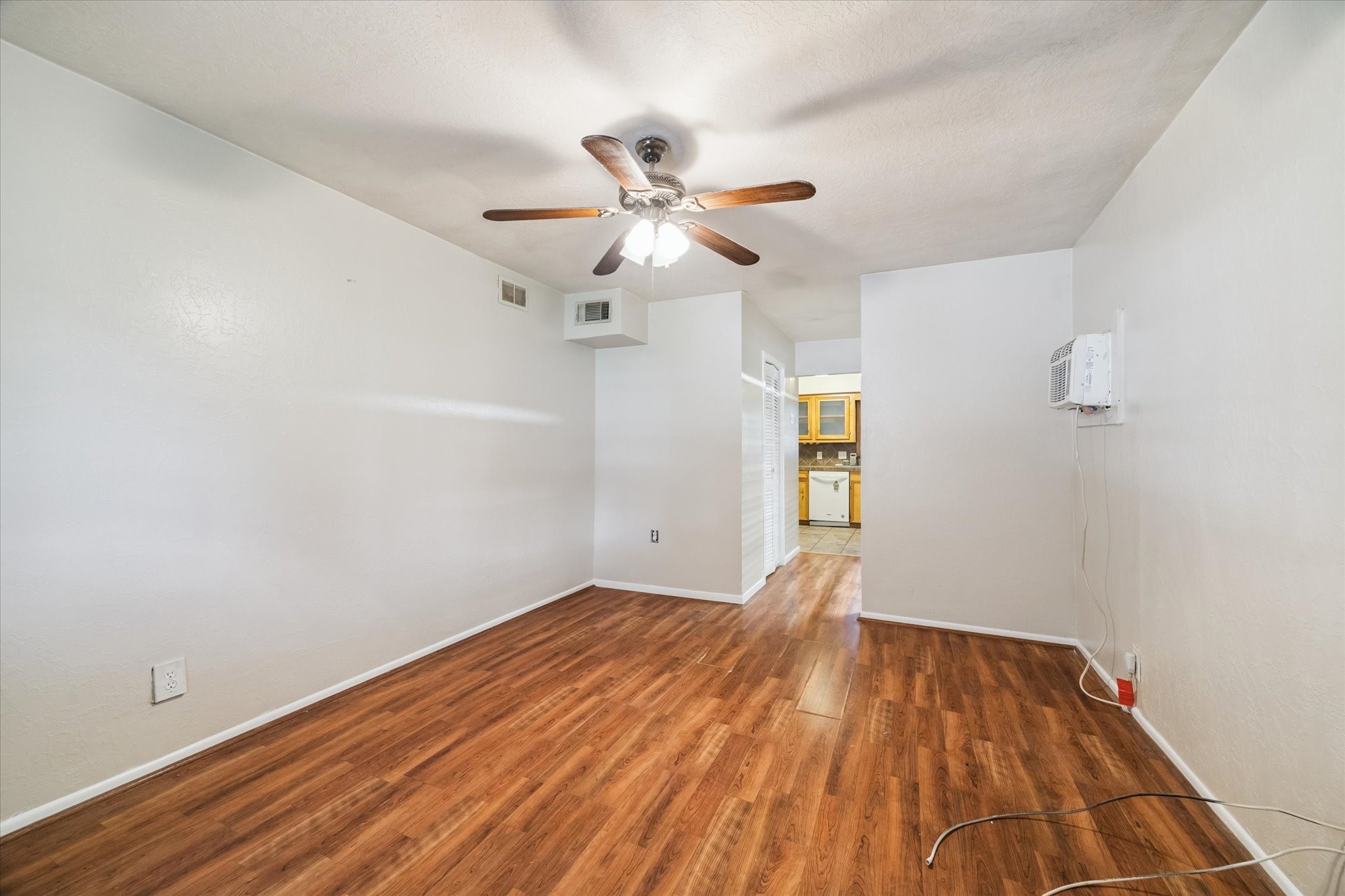5618 Sweetbriar Street Houston, TX 77017 - Photo 6 of 15 a view of empty room with wooden floor and fan