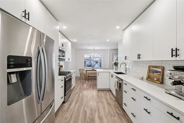 a kitchen with sink stove and cabinets