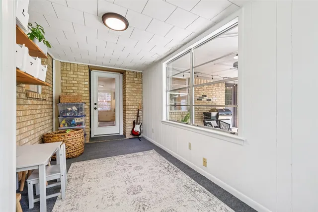 a room with gym equipment and a flat screen tv
