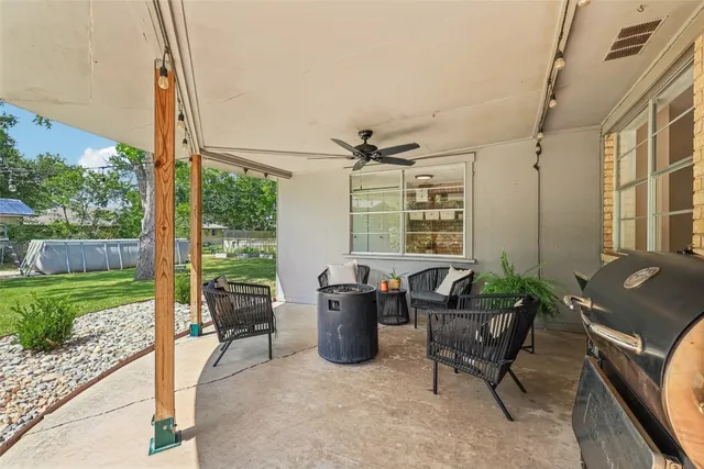 a living room with furniture and a floor to ceiling window
