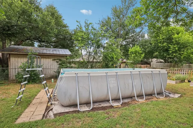 a view of a backyard with a small cabin and a chair