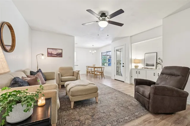 a living room with furniture and a ceiling fan