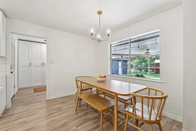 a kitchen with a sink a stove a refrigerator and white cabinets