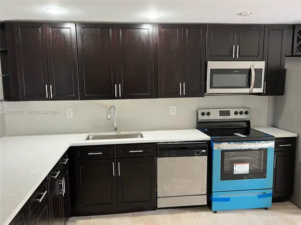 a kitchen with a sink and a microwave