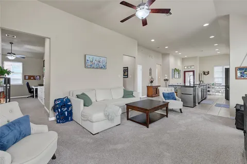 a living room with furniture and kitchen view