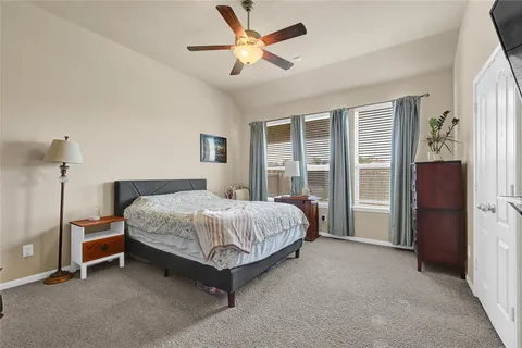 a spacious bedroom with a bed and a large window