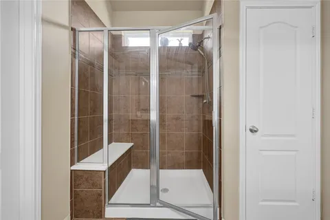 a bathroom with a shower and toilet