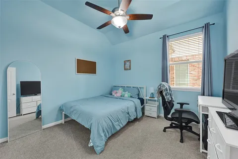 a bedroom that has a bed and a chair in it