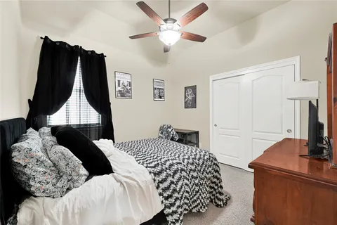 a bedroom with a bed and a wall painting