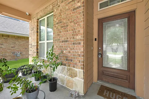 a view of a door and chair in the balcony