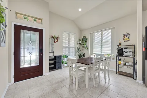 a dining room with furniture and window