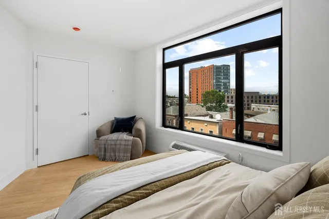a bedroom with a large bed and a large window