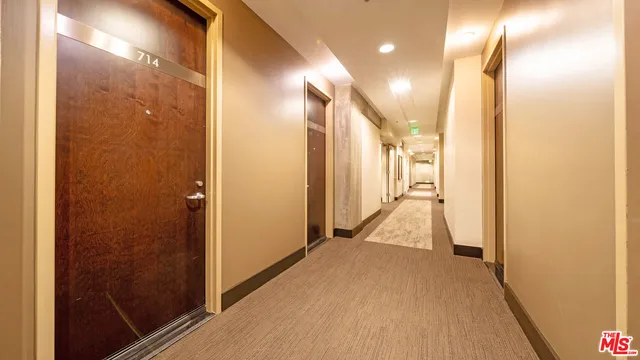 a view of hallway with wooden floor