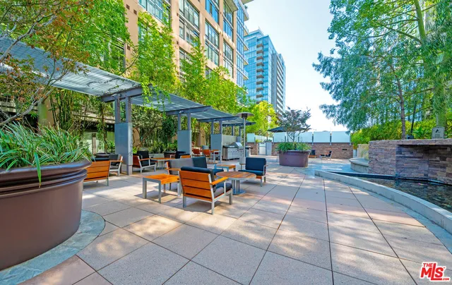 an outdoor space with patio furniture and potted plants