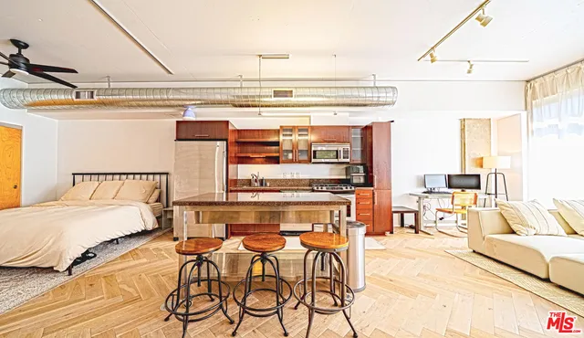 a living room with a couch and wooden floor