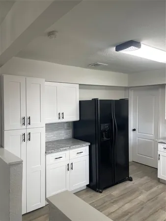 a kitchen with granite countertop a stove sink and microwave