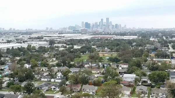 an aerial view of residential houses with outdoor space and street view
