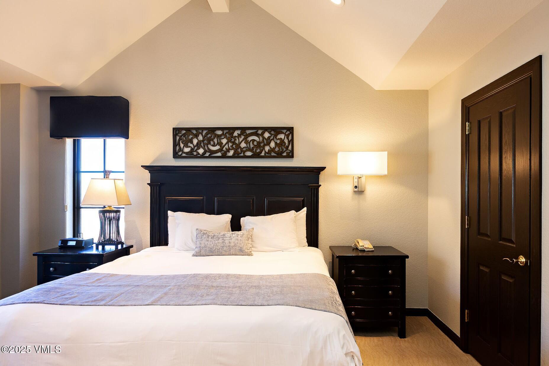 210 Offerson Road, Unit R203 WEEK 14 Beaver Creek, CO 81620 - Photo 12 of 31 a bedroom with a bed and a night stand