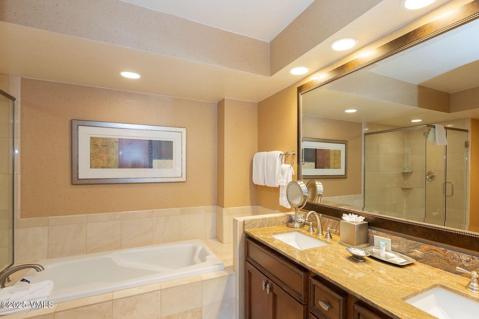 210 Offerson Road, Unit R203 WEEK 14 Beaver Creek, CO 81620 - Photo 14 of 31 a bathroom with a granite countertop sink mirror and a bath tub