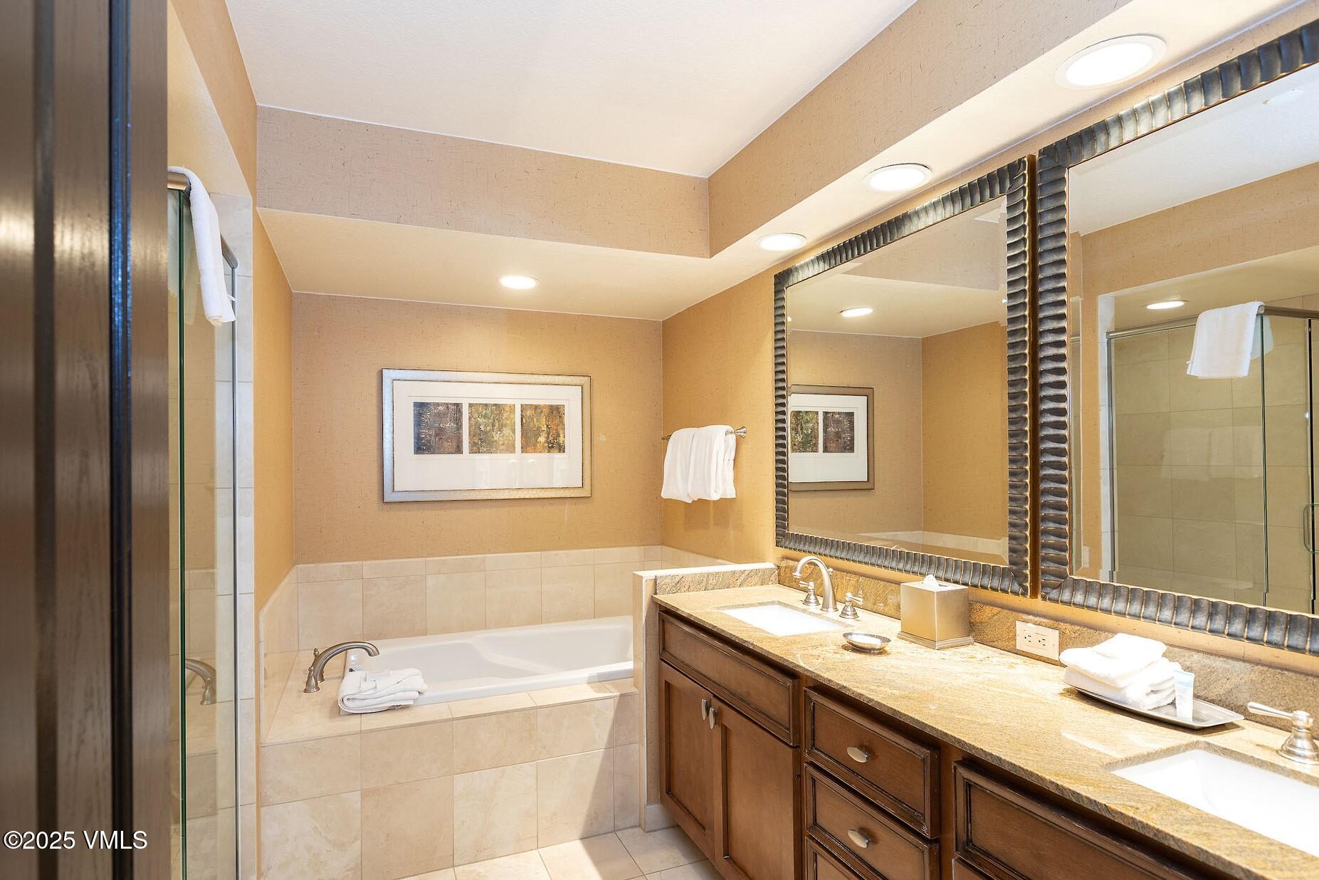 210 Offerson Road, Unit R203 WEEK 14 Beaver Creek, CO 81620 - Photo 20 of 31 a bathroom with a granite countertop tub sink and mirror