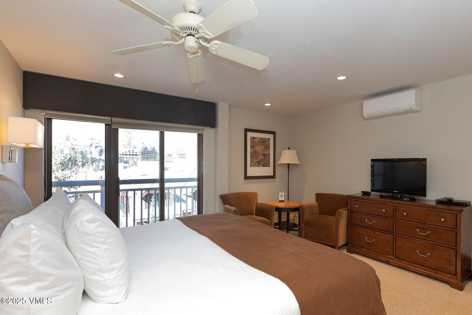 210 Offerson Road, Unit R203 WEEK 14 Beaver Creek, CO 81620 - Photo 23 of 31 a bedroom with a large bed and a flat tv screen on dresser