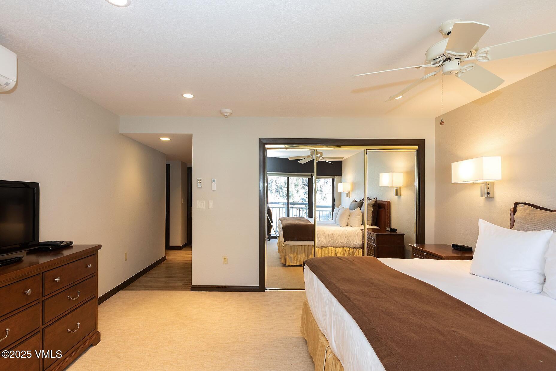 210 Offerson Road, Unit R203 WEEK 14 Beaver Creek, CO 81620 - Photo 24 of 31 a large bedroom with a large bed and wooden floor