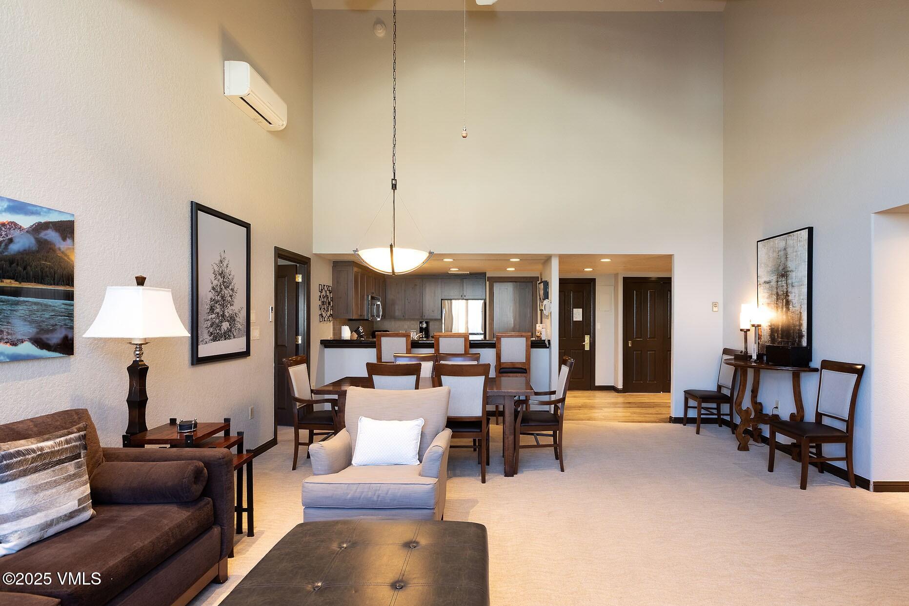 210 Offerson Road, Unit R203 WEEK 14 Beaver Creek, CO 81620 - Photo 6 of 31 a living room with furniture kitchen view and a chandelier