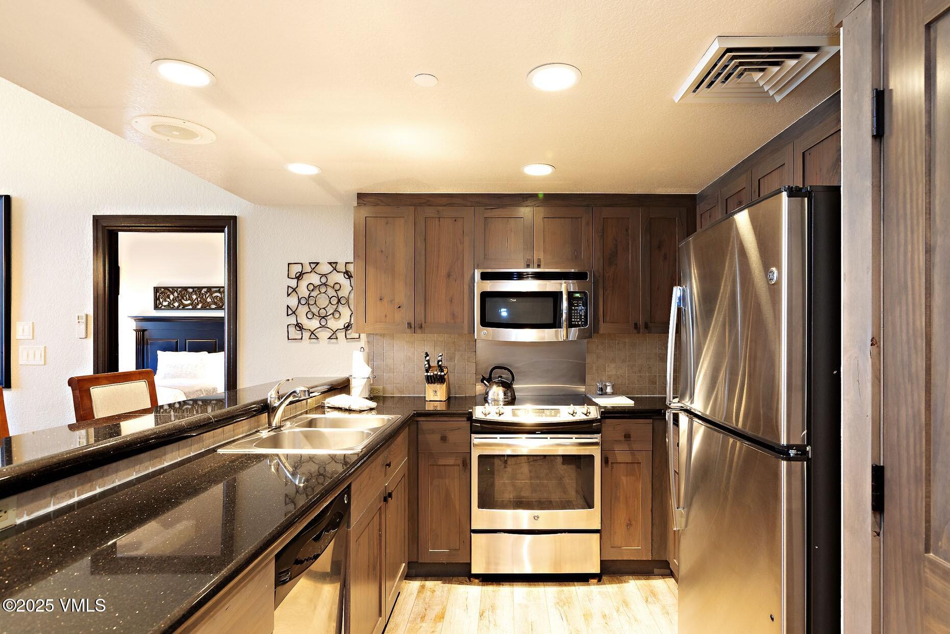 210 Offerson Road, Unit R203 WEEK 14 Beaver Creek, CO 81620 - Photo 9 of 31 a kitchen with a refrigerator sink and microwave