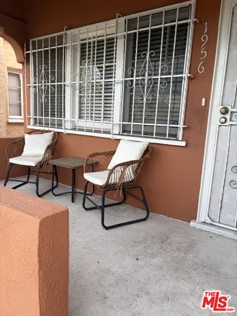 a balcony with table and chairs