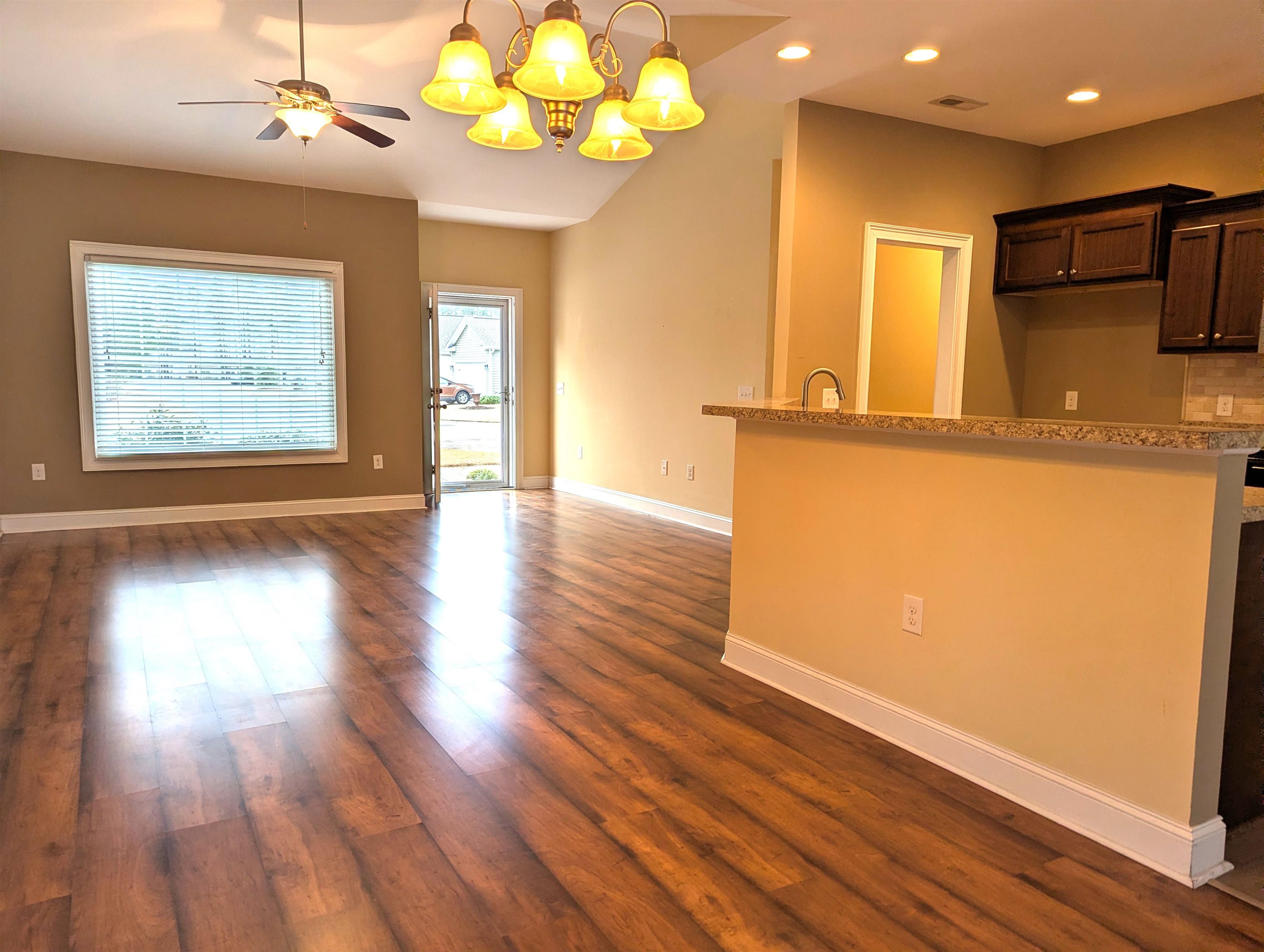 1100 Eureka Trail Longs, SC 29568 - Photo 40 of 40 Kitchen featuring a chandelier, dark brown cabinetry, dark wood-type flooring, open floor plan, and recessed lighting
