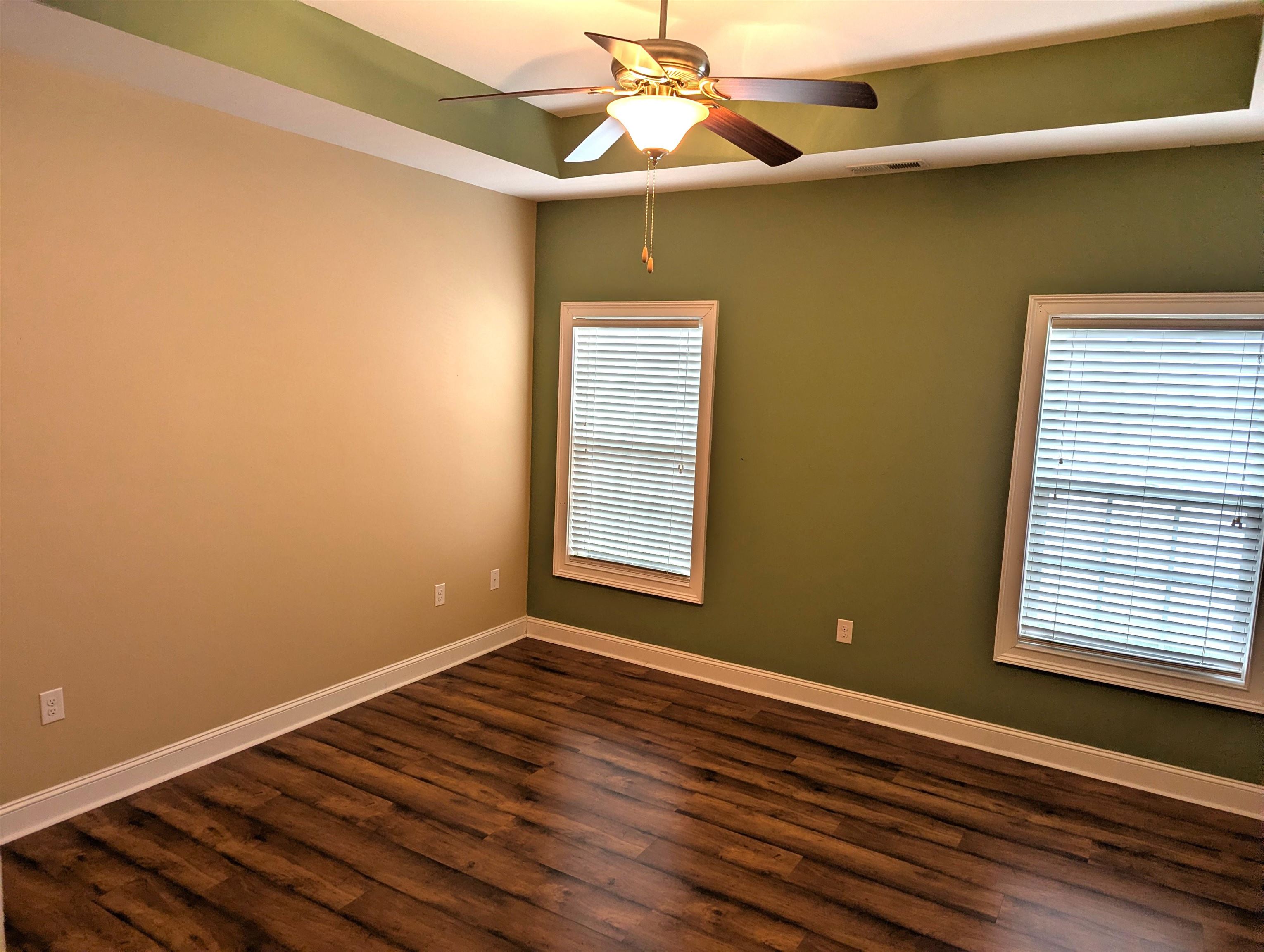 1100 Eureka Trail Longs, SC 29568 - Photo 14 of 40 Empty room with dark wood finished floors, a raised ceiling, and ceiling fan