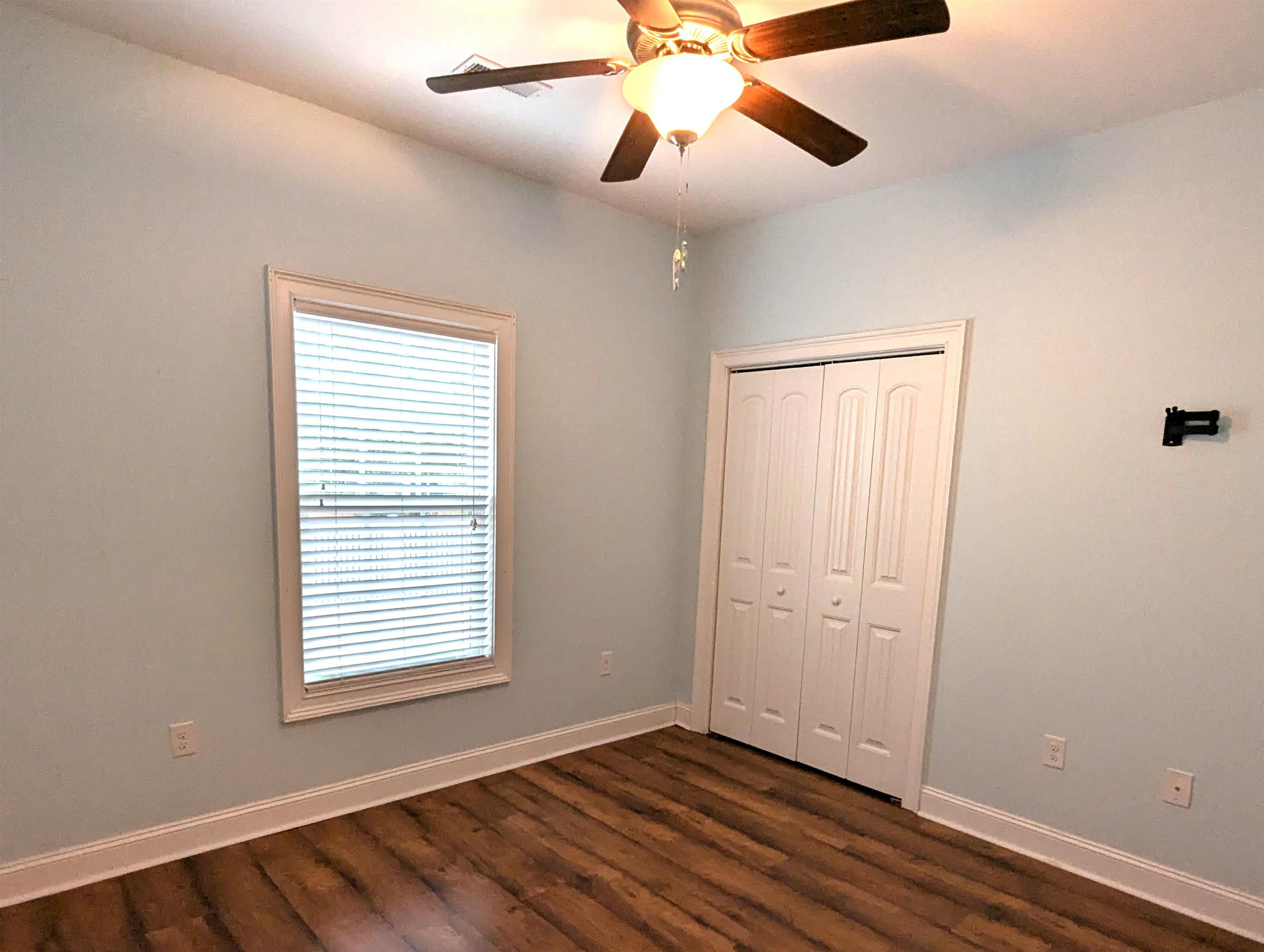 1100 Eureka Trail Longs, SC 29568 - Photo 21 of 40 Unfurnished bedroom with dark wood-style flooring, a ceiling fan, and a closet