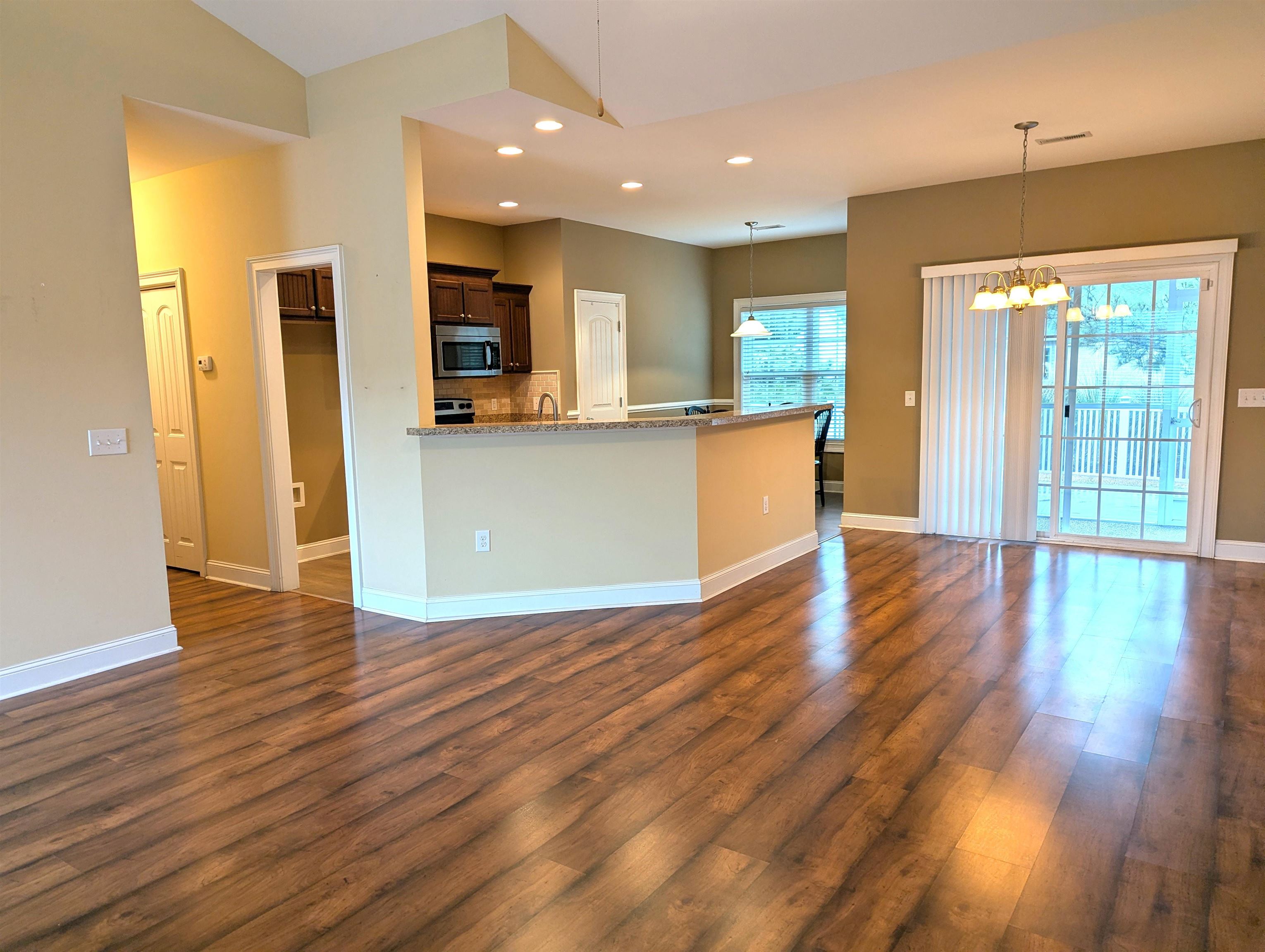 1100 Eureka Trail Longs, SC 29568 - Photo 8 of 40 Kitchen featuring recessed lighting, hanging light fixtures, stainless steel microwave, light stone countertops, and a chandelier