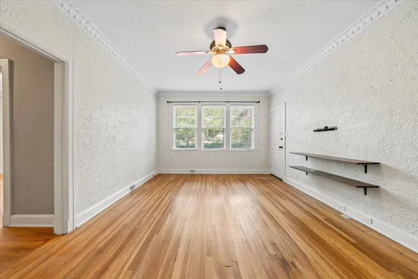 wooden floor in an empty room with a window