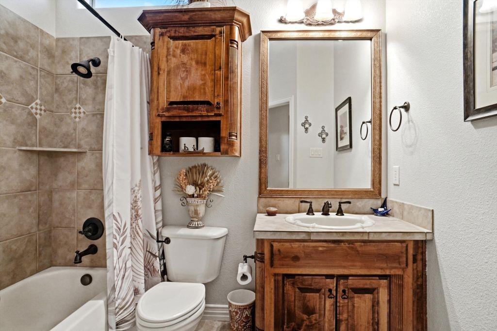 620 Highview Lane Hurst, TX 76054 - Photo 31 of 40 a bathroom with a sink a toilet and shower